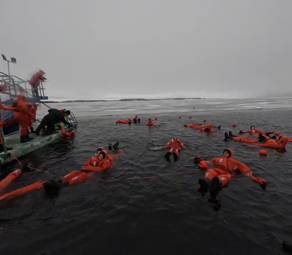 Passengers floating beside the boarding platform at the ice edge